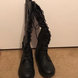 Black lace up combat boots.